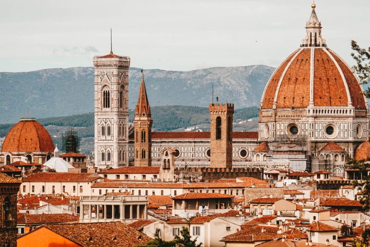 a group of people in front of a large church with Florence Cathedral in the background