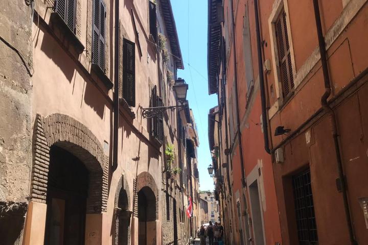 a narrow city street with buildings on the side of a building