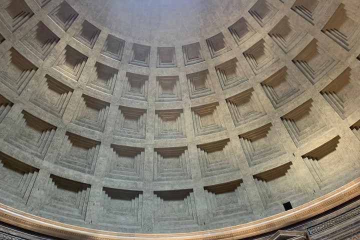 Interior view of a dome with a central oculus allowing light to enter.